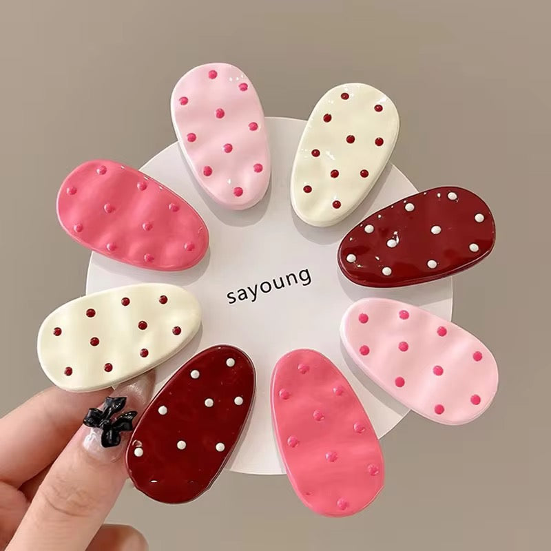 White polka dot hair clips worn in hair