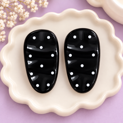 Assorted pairs of oval polka dot hair clips on cards