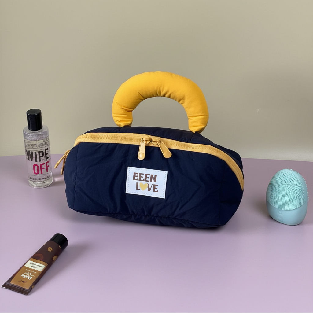 Navy blue quilted travel storage bag with yellow handle and zipper