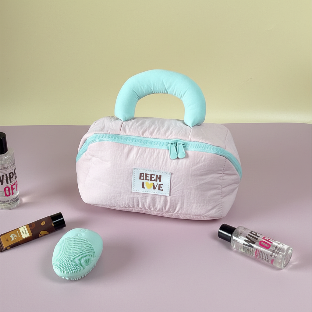 Light pink quilted travel storage bag with mint handle and zipper